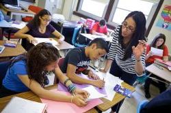 Photo of teacher with students in a classroom.