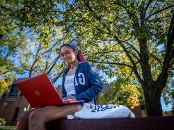 Montclair State University student on laptop.